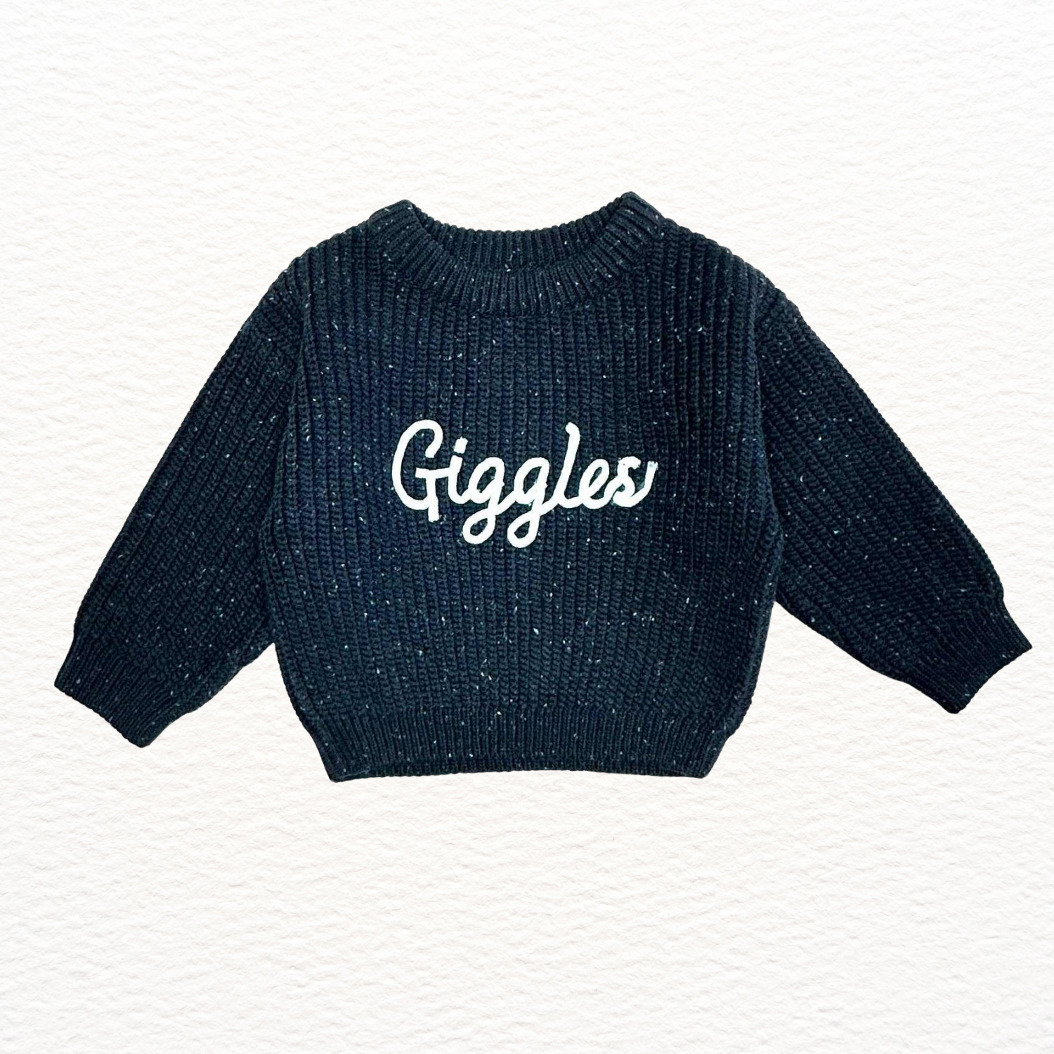 Navy blue sweater with 'Giggles' text on a white background