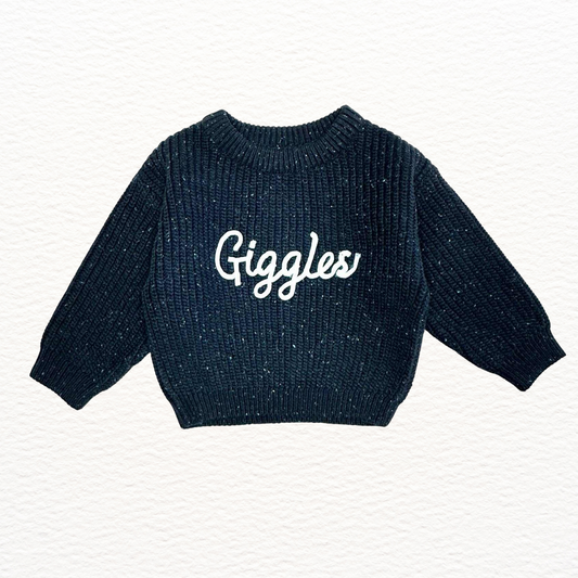 Navy blue sweater with 'Giggles' text on a white background