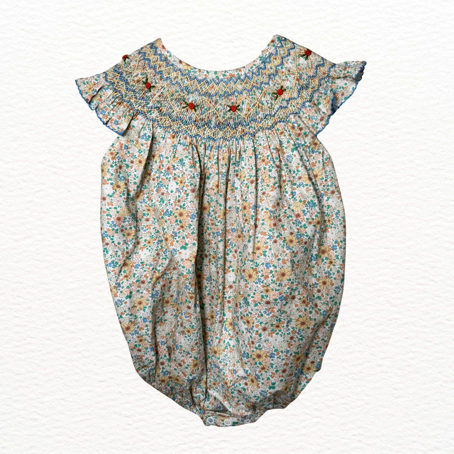 Floral baby romper with ruffled collar on a white background